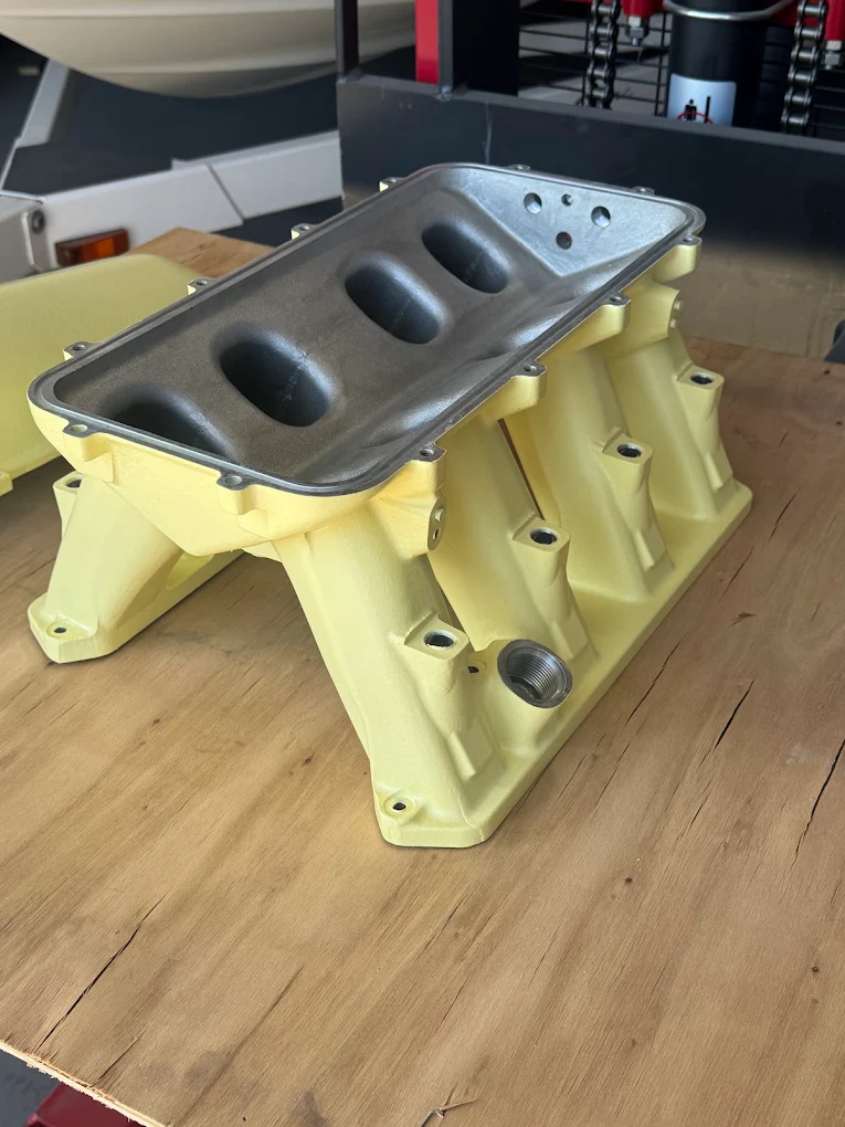 Engine intake manifold powder-coated in a custom yellow finish
